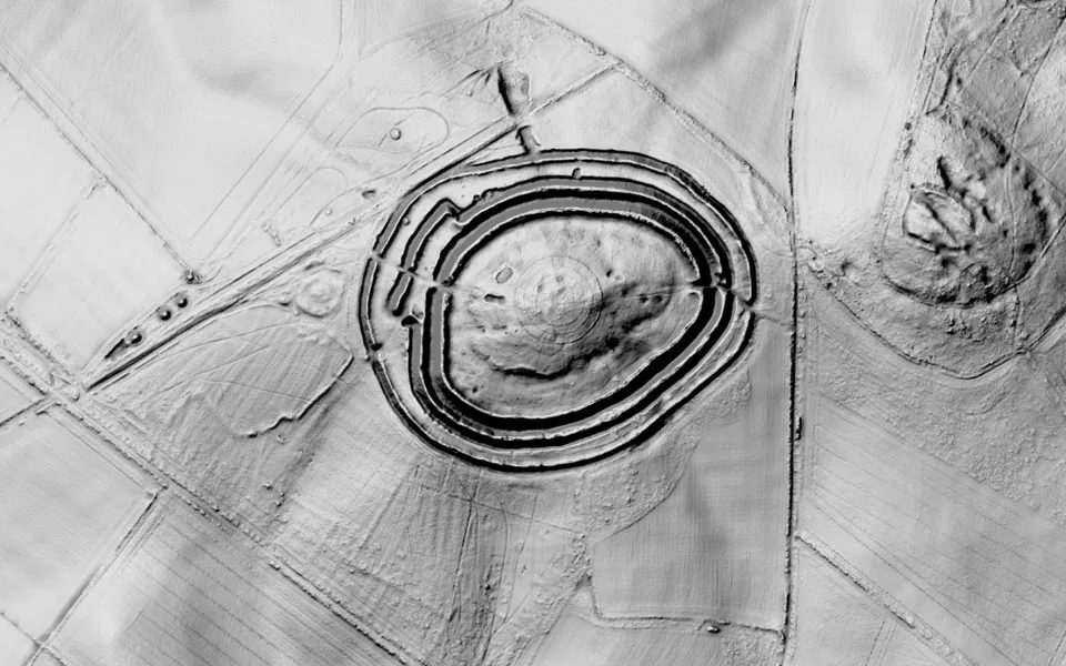 LiDAR terrain shading of Badbury Rings in Dorset: three concentric rings of banks and ditches around a wooded hilltop.