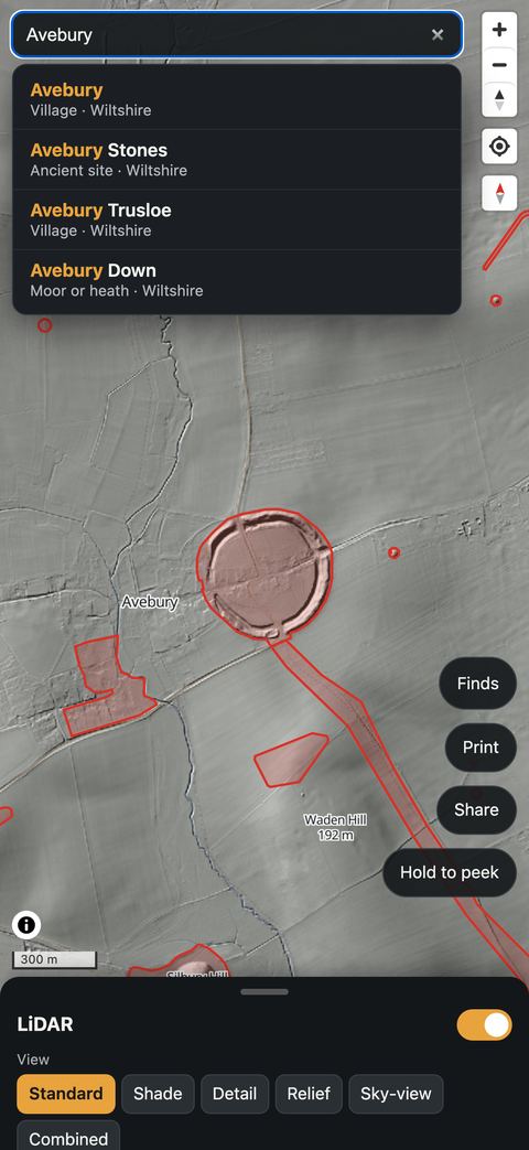 The app's search listing places called Avebury, with the Avebury henge outlined on the map.