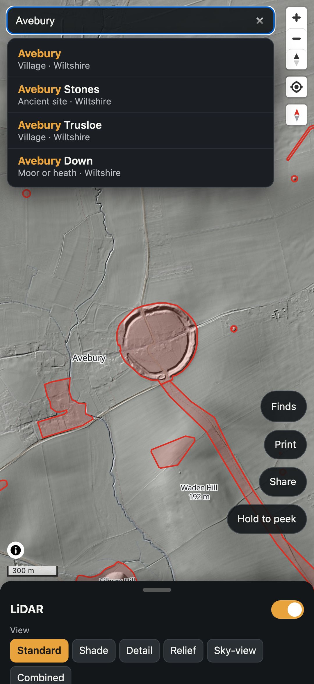 The app's search listing places called Avebury, with the Avebury henge outlined on the map.