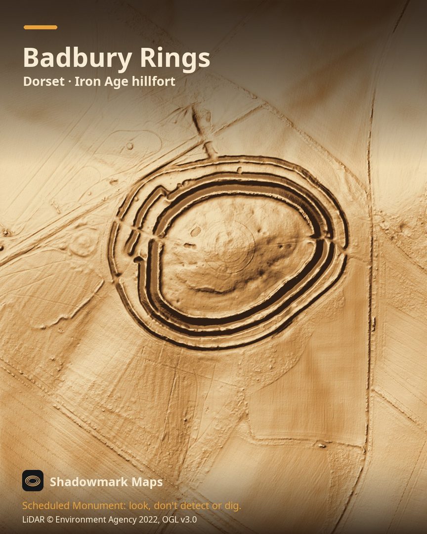 LiDAR terrain shading of Badbury Rings, Dorset. Look for three concentric rings of bank and ditch with gaps for entrances, and the raised line of the Roman road passing just to the north-west.